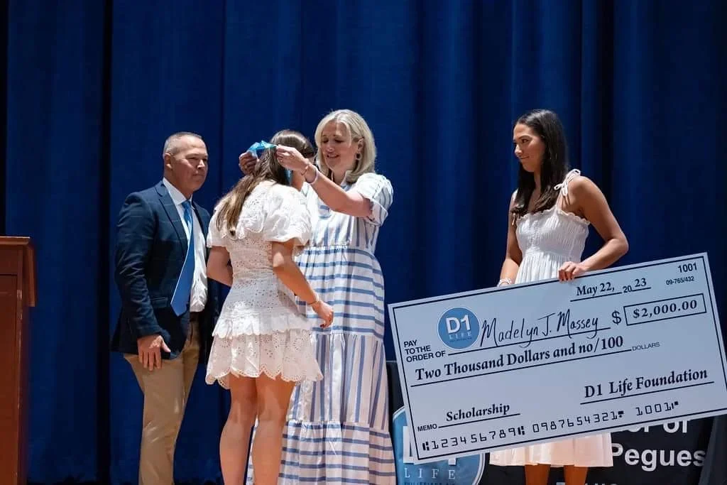 D1 Life Scholarship check and medal